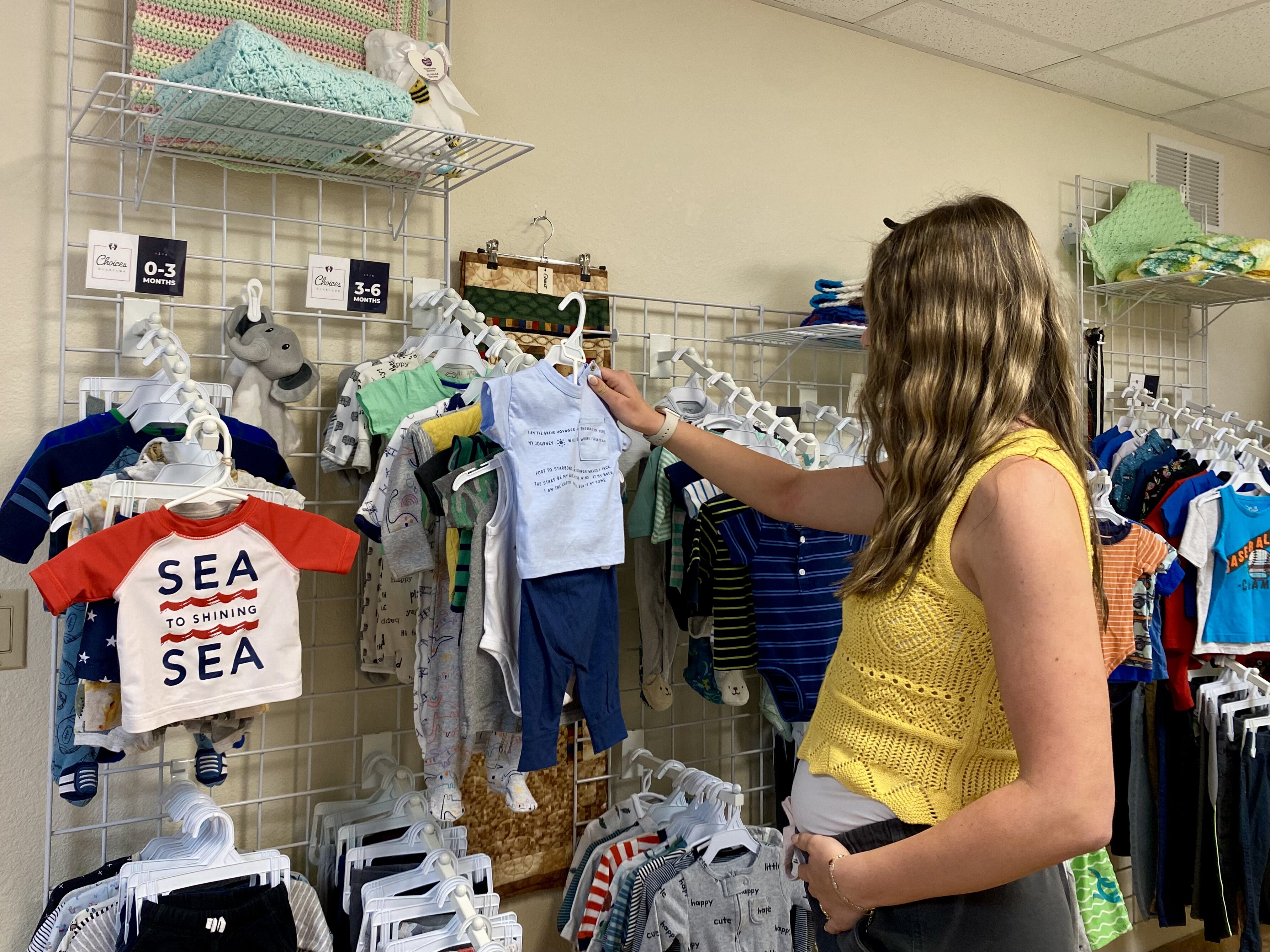 Soon to be Mom with donated baby clothes - free baby items Phoenix